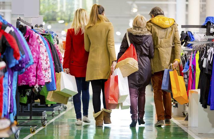 Family carrying shopping bags in mall