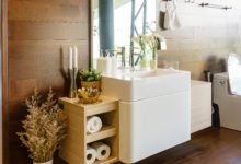 Modern spacious bathroom with bright tiles with toilet and sink. Side view
